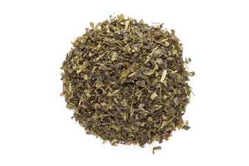 Organic Green tea (Camellia sinensis) Tea bag cut, dried leaves, isolated on white background. Macro close up. Top view.