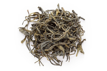 Organic Green Tea (Camellia sinensis) dried long leaves isolated on white background. Macro close up. Top view.