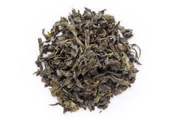 Organic Green Tea (Camellia sinensis) dried long leaves isolated on white background. Macro close up. Top view.