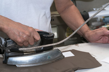 Production process of suit tailoring. Ironing of parts of a tailored jacket
