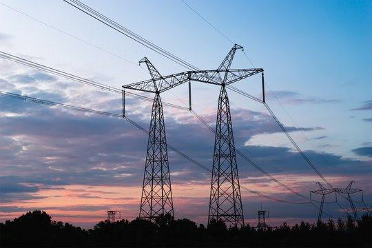 Mast electrical power line against cloud and blue sky