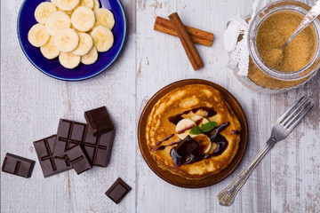 Delicious pancakes with bananas and chocolate.