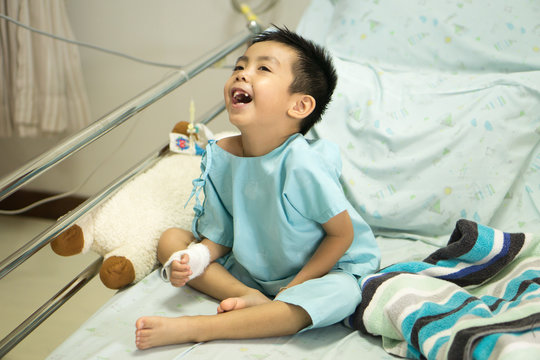 A sick Little boy in hospital bed.