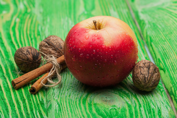 walnut apple and cinnamon on green wood