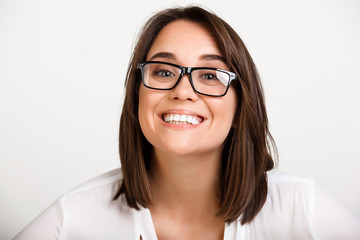 Portrait of girl playing ape over white background.