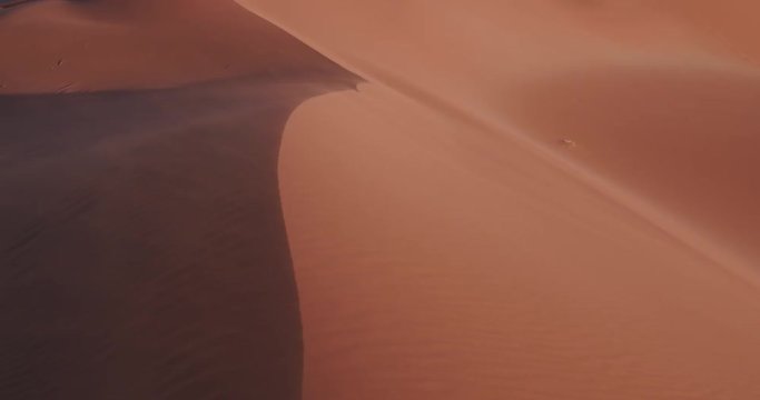 4K static shot of sand blowing over the sand dunes inside the Namib-Naukluft National Park