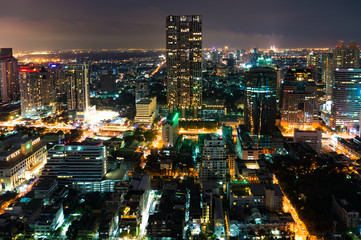 Naklejka na ściany i meble Aerial view of Bangkok city at night. View from above on modern Asian megalopolis cityscape at night