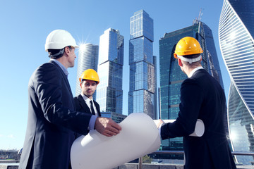 Architects with blueprint