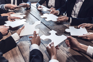 Business people and puzzle