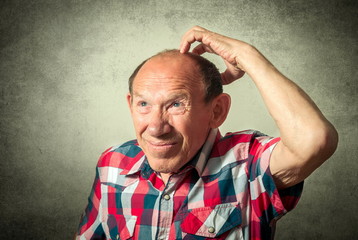 portrait of the funny senior man thinking