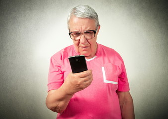 Fototapeta premium portrait of the senior woman looking on phone