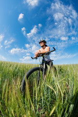 Happy Young Woman riding bicycle outside