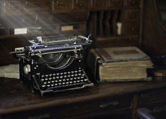 Vintage Typewriter in Old Office with sunbeams and books