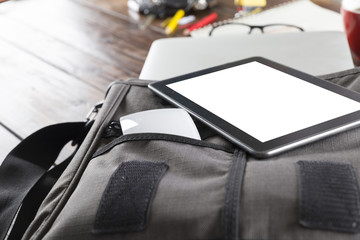 digital tablet, mouse on bag on office desk