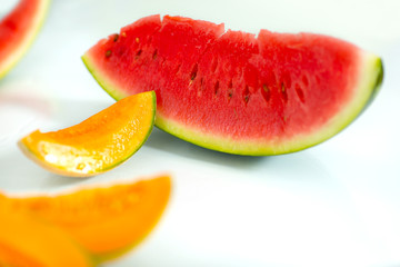Slice of watermelon and melon on white background