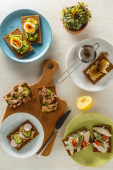 Healthy sandwiches with various fillings on crisp rye bread.