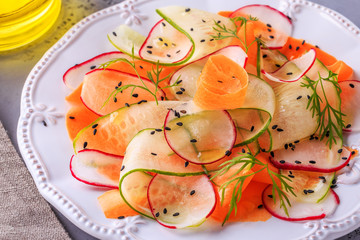 Vegetarian salad of carrot, cucumber and radish.