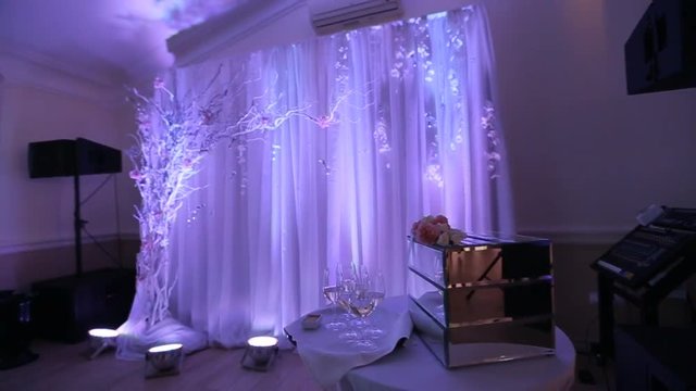 Interior of a wedding hall decoration ready for guests.Beautiful room for ceremonies and weddings.Wedding concept.Luxury stylish wedding reception purple decorations expensive hall.Wedding decor