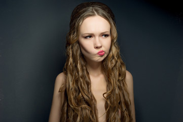 Fototapeta premium Portrait of a thinking beautiful young woman