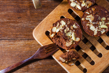 Homemade delicious fresh chocolate and almonds cake on wooden ta