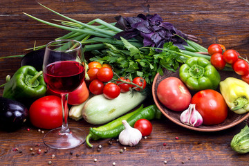 glass of red wine on a background of vegetables