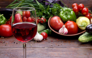 glass of red wine on a background of vegetables