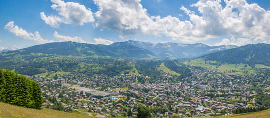 Panorama of the village of Megeve and surrounding mountains during summertime.