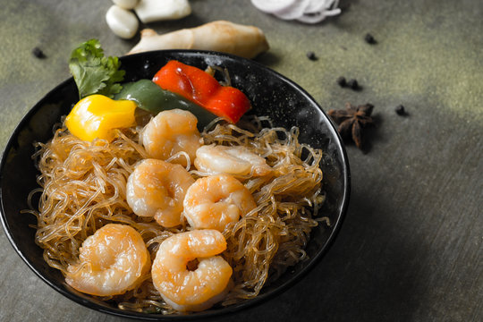 Casserole prawns with glass noodles / Shrimp potted with vermicelli. Close up.