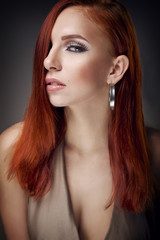 Naklejka premium portrait of a girl with red earring