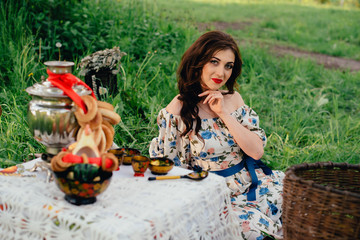 Fototapeta premium Beautiful Russian girl in the decoration on the nature