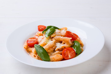 penne with tomato in white plate