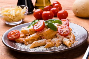 penne with tomato in brown plate