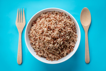 Brown Rice on pastel blue background.