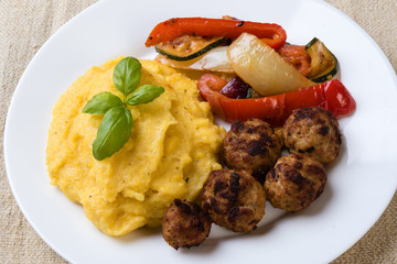 polenta with meatballs and vegetables
