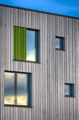 Modern building facade windows.Asymmetrically placed windows in facade of contemporary school. Munich, Germany