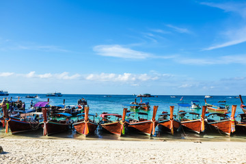 Fototapeta na wymiar Longtail fishery and travel boat park on sand beach
