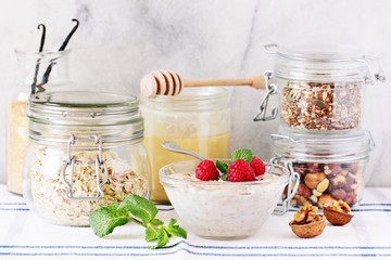 Overnight oats with raspberry and various superfoods toppings.Healthy eating concept. Selective focus