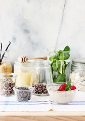 Overnight oats with raspberry and various superfoods toppings.Healthy eating concept. Selective focus