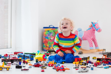 Little boy playing with toy cars