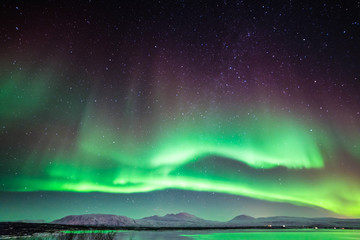 An aurora, sometimes referred to as a polar light, is a natural light display in the sky, predominantly seen in the high latitude (Arctic and Antarctic) regions. - obrazy, fototapety, plakaty