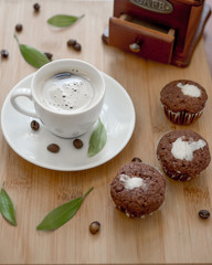 Coffee  and three muffins on wooden table.Selective focus
