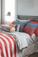 colorful pillows on bed in single bedroom