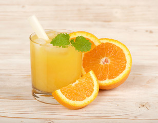 fresh orange juice on a wooden background