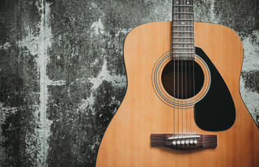 detail of classic guitar with grunge background