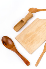 Kitchen wooden utensils flat lay over white background