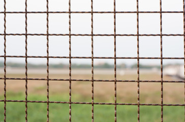 Wire mesh background blur airport runway.