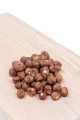 Bunch of raw hazelnut on the wooden board