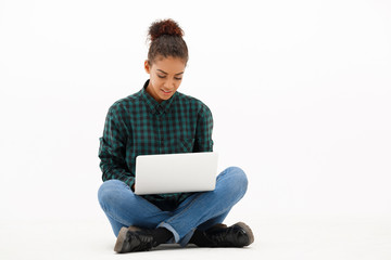 Portrait of young african girl with laptop over white background