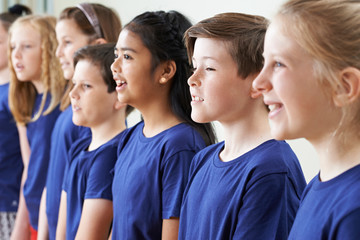 Group Of School Children Singing In Choir Together