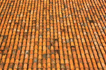 Old orange weathered roof shingles and ceramic tiles pattern bac